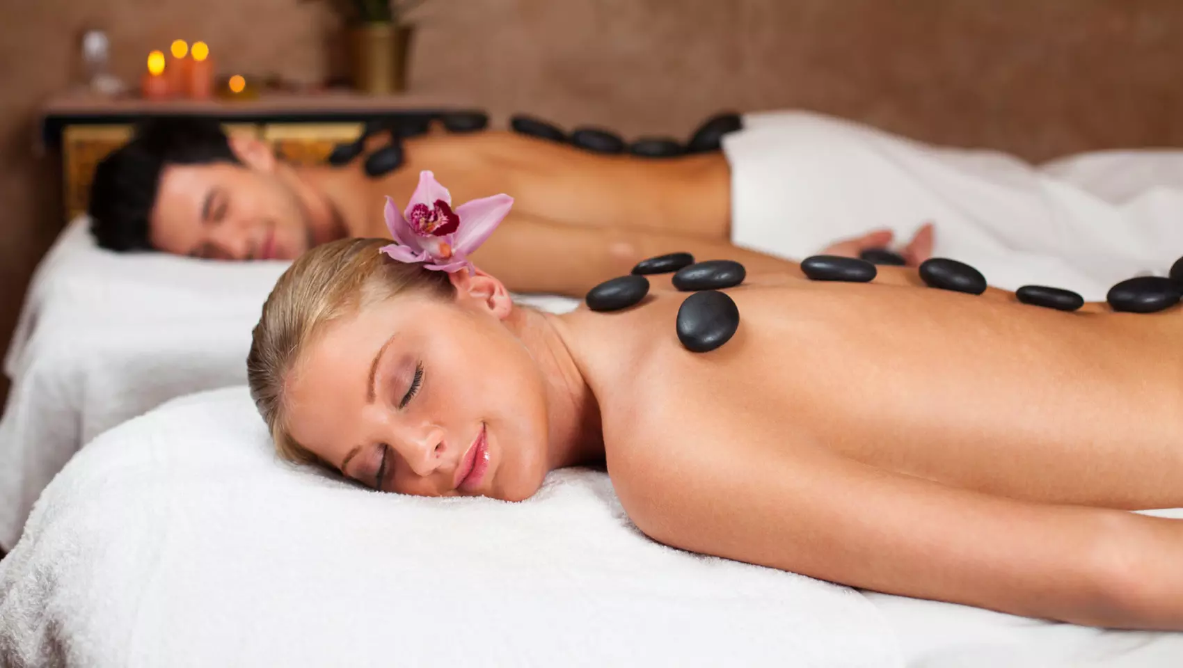 Couple getting hot stone massage treatment
